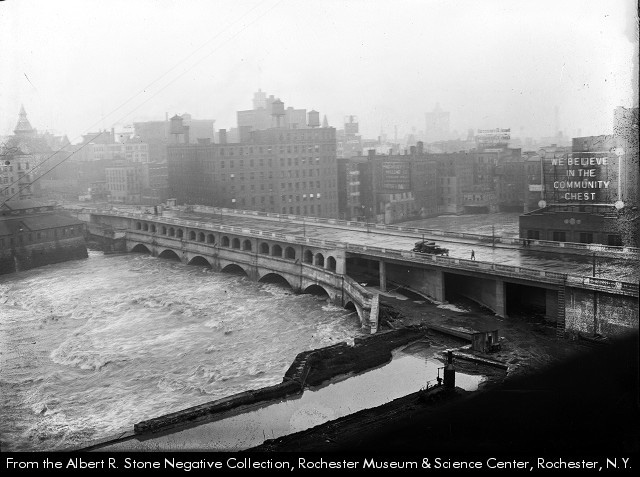 Title: Aqueduct becomes Broad Street Bridge [photograph].  Photographer/Artist: Stone, Albert R., 1866-1934. Date: 1924? Physical Details: 1 photograph : b&w ; 5 x 5 in. Collection: Albert R. Stone Negative Collection, Rochester Museum & Science Center, Rochester, NY Summary: Work proceeds on the Broad Street Bridge. The lower level, which will become the subway, has been opened to ground level at the east end of the bridge. Flood waters almost fill the lower archways. The Broad Street Bridge was built between 1922-1924 over what had been the 1842 Erie Canal Aqueduct. Rochester Images image Number: sct09735 http://www.rochester.lib.ny.us/rochimag/rmsc/ scm09/scm09735.jpg